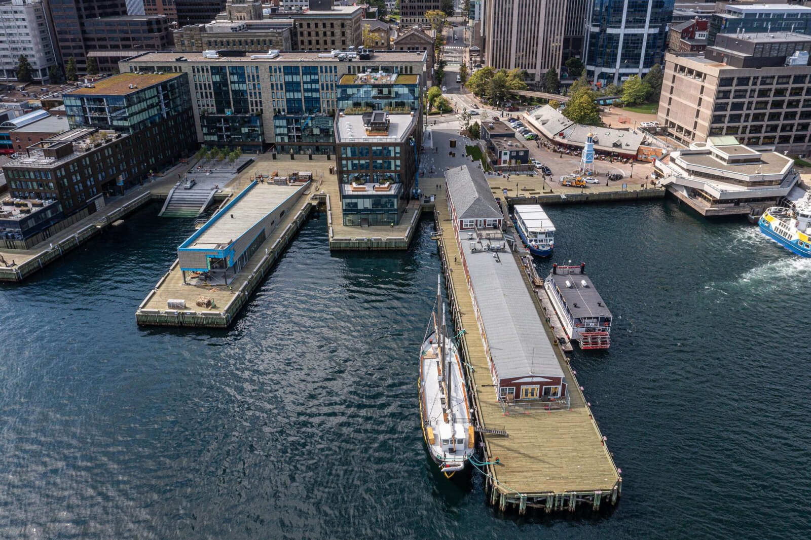Aerial photo of city waterfront with wharfs, boats and buildings